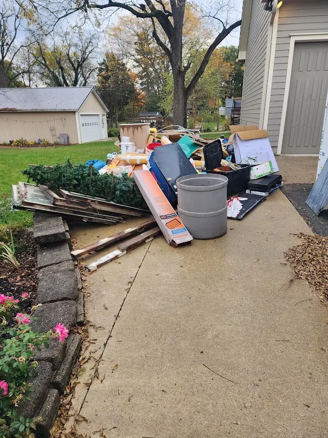 Dumpster being loaded with debris for Commercial Dumpster Rental in De Soto